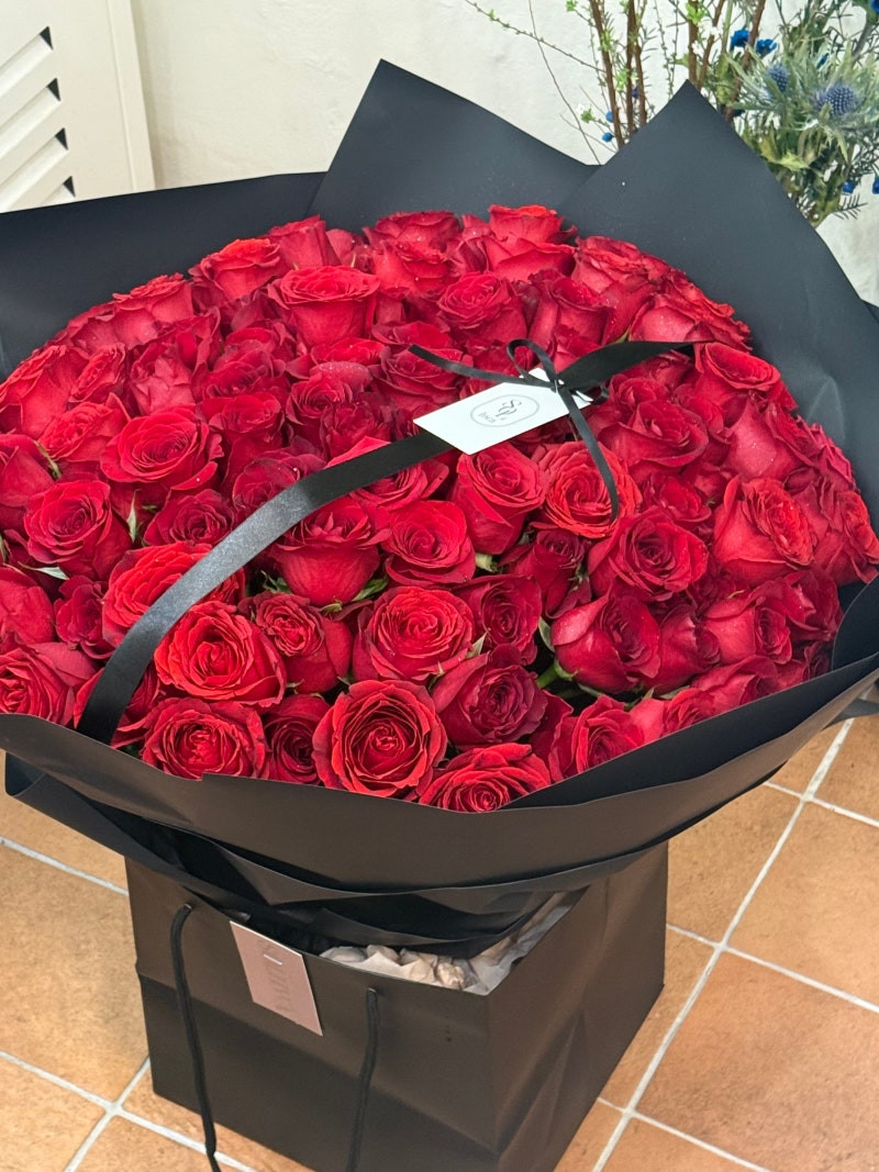 Red roses in black wrapping